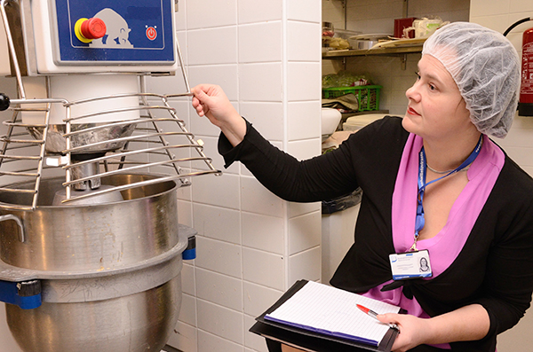 Occupational safety inspector in the kitchen.