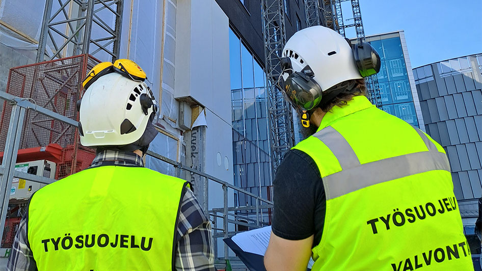 Two occupational safety and health inspectors inspecting a construction site.