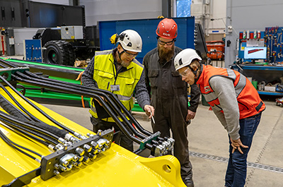 Three people with occupational health and safety inspection.